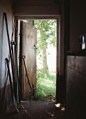 Gardening equipment in barn with open wooden door