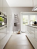 Bright, modern kitchen with grey walls and white units
