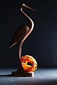 A wooden bird with a nest of tomato tagliatelle