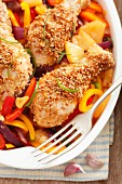 Chicken legs with sesame seeds, peppers and pineapple