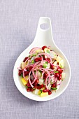 Potato and herring salad with kidney beans and red onions