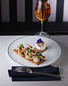 Mushroom pancake with mozzarella, truffle slices and a pansy