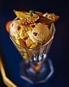 Ice cream sundae with fruit and gold leaf