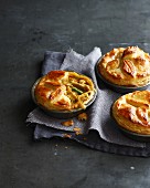 Still life of three chicken pies made with puff pastry