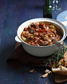 Beef daube in casserole dish with baguette