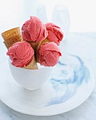 Bowl of ice cream cones filled with strawberry ice cream