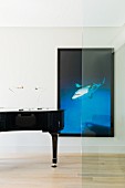 Black concert piano and photographic artwork with black frame