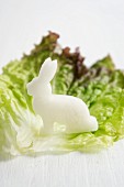 A radish rabbit on a lettuce leaf