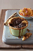 Individual pie made with haunch of venison, served with carrot and onion salad