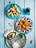 Spring rolls and vegetable cakes with dips