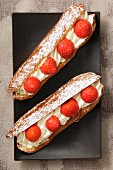Eclairs with cream and strawberries