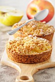 Apple crumble tartlets on a chopping board