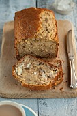 Banana bread with butter on a chopping board