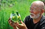 Man looking at romanesco cauliflower