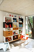 Shelving unit and designer rocking chair in purist, child's bedroom