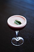 A Cocktail with Foam and Garnished with Mint