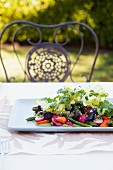 A Spring Vegetable Salad on a Platter on an Outdoor Table