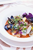 Assorted Shellfish in a Tomato Broth with Micro Greens