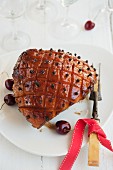 Glazed ham with cloves and cherries, for Christmas