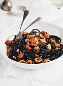 Squid ink spaghetti with mussels and tomatoes