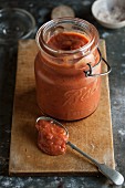 Home-made tomato sauce in a jar and on a spoon