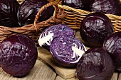 Red cabbage in baskets and on a chopping board, whole and cut in half