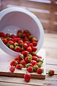 Fresh strawberries falling out of a colander