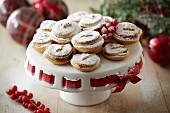 Mince pies with icing sugar on a cake stand for Christmas