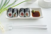 Maki sushi with tuna, salmon and cucumber, with soy sauce and wasabi