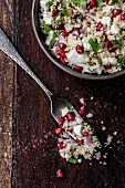 Couscous salad with pomegranate seeds, feta and mint