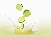 Limes falling into lime juice