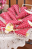 Polka-dotted paper cones of petals on tray in garden for wedding confetti