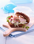 Wholemeal bread roll with radish creme and turkey ham