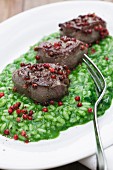 Parsley risotto with venison fillets and pink peppercorns