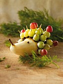 A pear hedgehog with grapes
