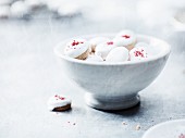 Pfeffernüsse (spiced soft gingerbread from Germany) with red sugar in a bowl