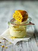 Squash scone on top of a jar of butter