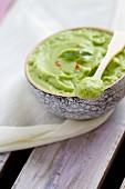 Avocado purée with pink peppercorns (close-up)