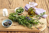 Fresh hyssop and olive oil infused with hyssop on a chopping board