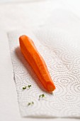 A peeled carrot on kitchen paper