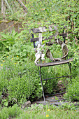 Angel figurine on willow wreath on weathered garden chair
