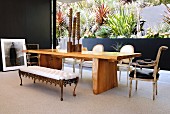 Dining area with seats of various styles in front of patio-style courtyard with plants in terraced beds