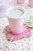 Strawberry and banana milk in a polka-dot cup