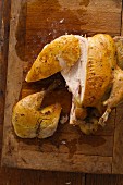 Roasted Chicken on a Wooden Cutting Board Sliced