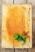 A bouquet of herbs, with parsley, bay and thyme, on a chopping board