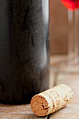 A wine cork with an old wine bottle
