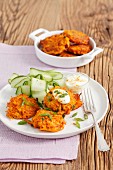 Carrot fritters with curry, spring onions and cucumber salad