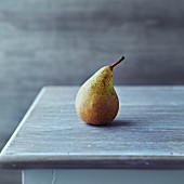 simple still life with an autumn conference pear