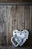 Two old fashion christmas hearts on a wooden wall