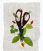 Herbs and herb snippers under wire mesh, backlit